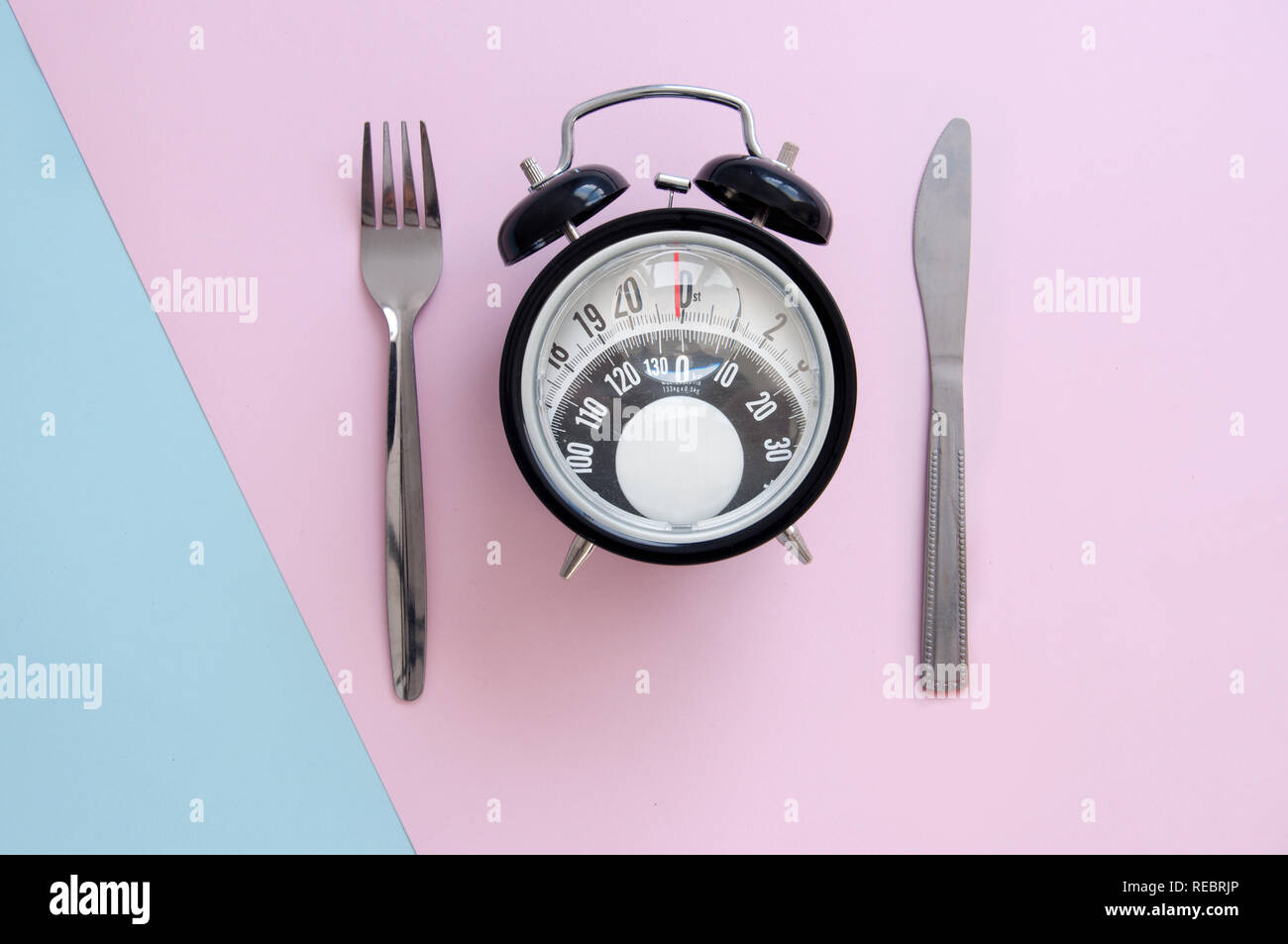 Clock with bathroom scales monitor and fork and knife Stock Photo Alamy