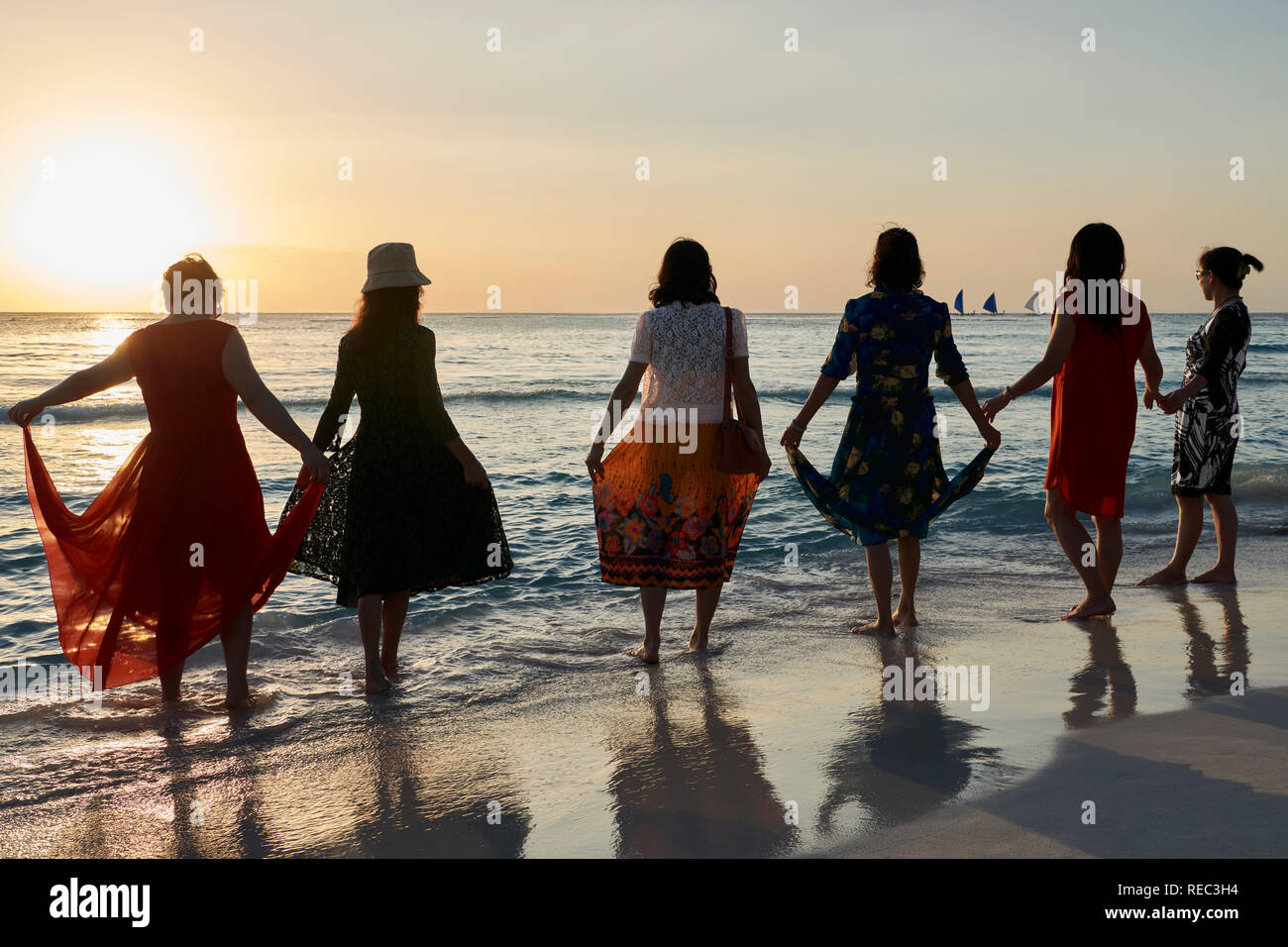 Group of Asian women tourists watching the sunset on Boracay Island, Philippines Stock Photo