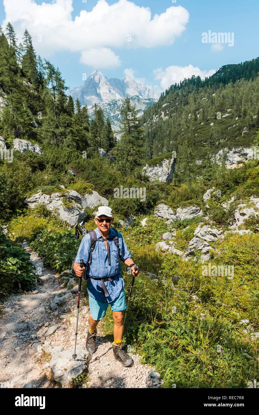 Hiker on hiking trail to Kärlingerhaus, Watzmann in the back, Berchtesgaden National Park, Berchtesgadener Land, Upper Bavaria Stock Photo