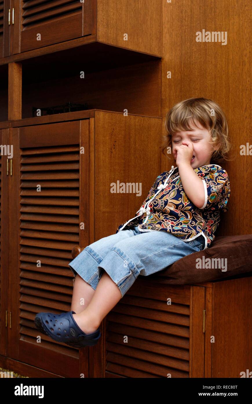 Two year old girl having a tantrum sitting on 'naughty chair Stock