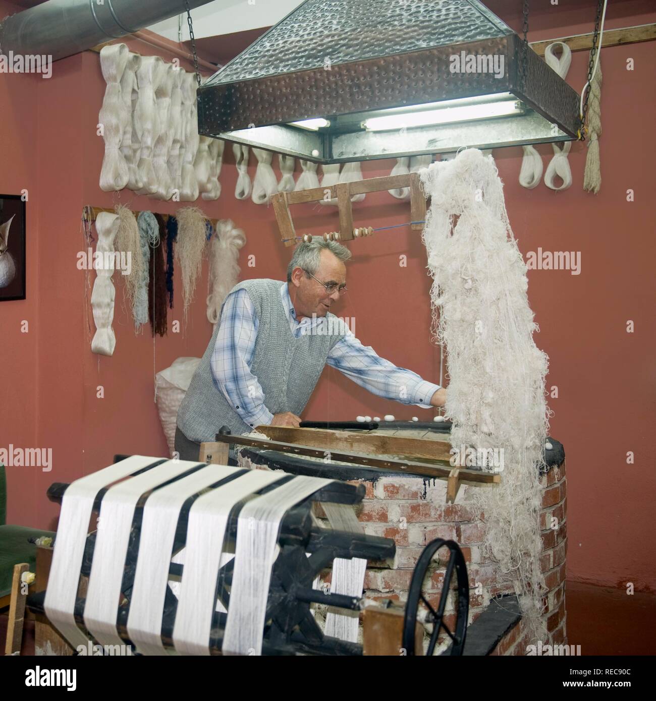 Man extracting silk filaments from cocoons, Antalya, Turkey Stock Photo