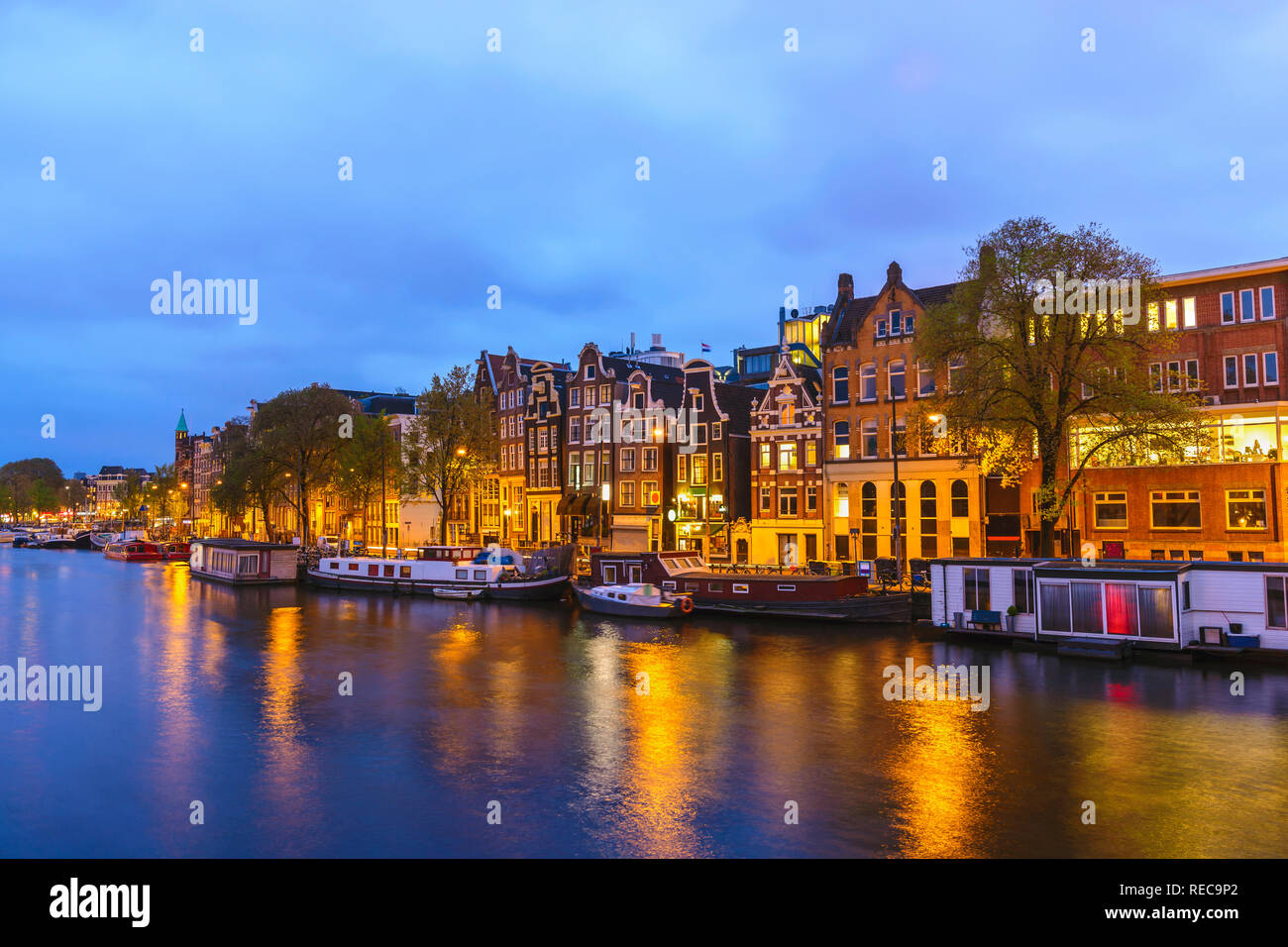Amsterdam Netherlands, night city skyline at canal waterfront Stock Photo
