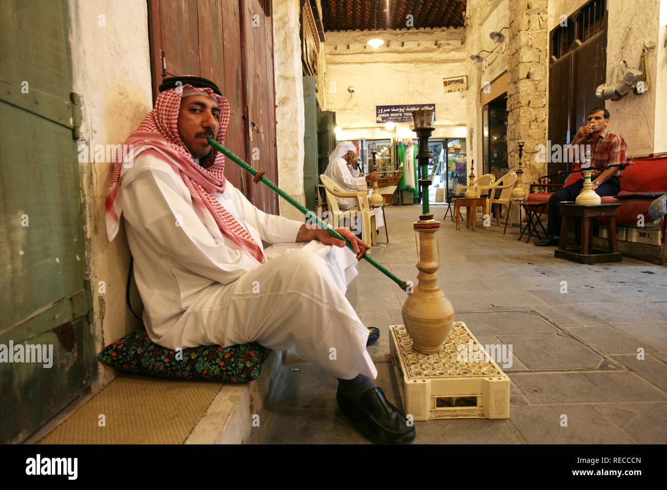 Men using a hookah or shisha in a cafe in Souq al Waqif market, the