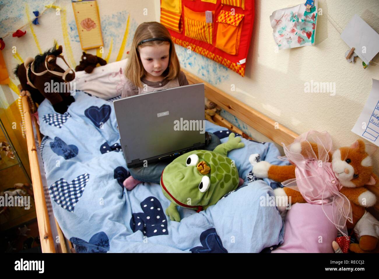 Girl 7 Years Old Working With A Computer At Home In Her Room