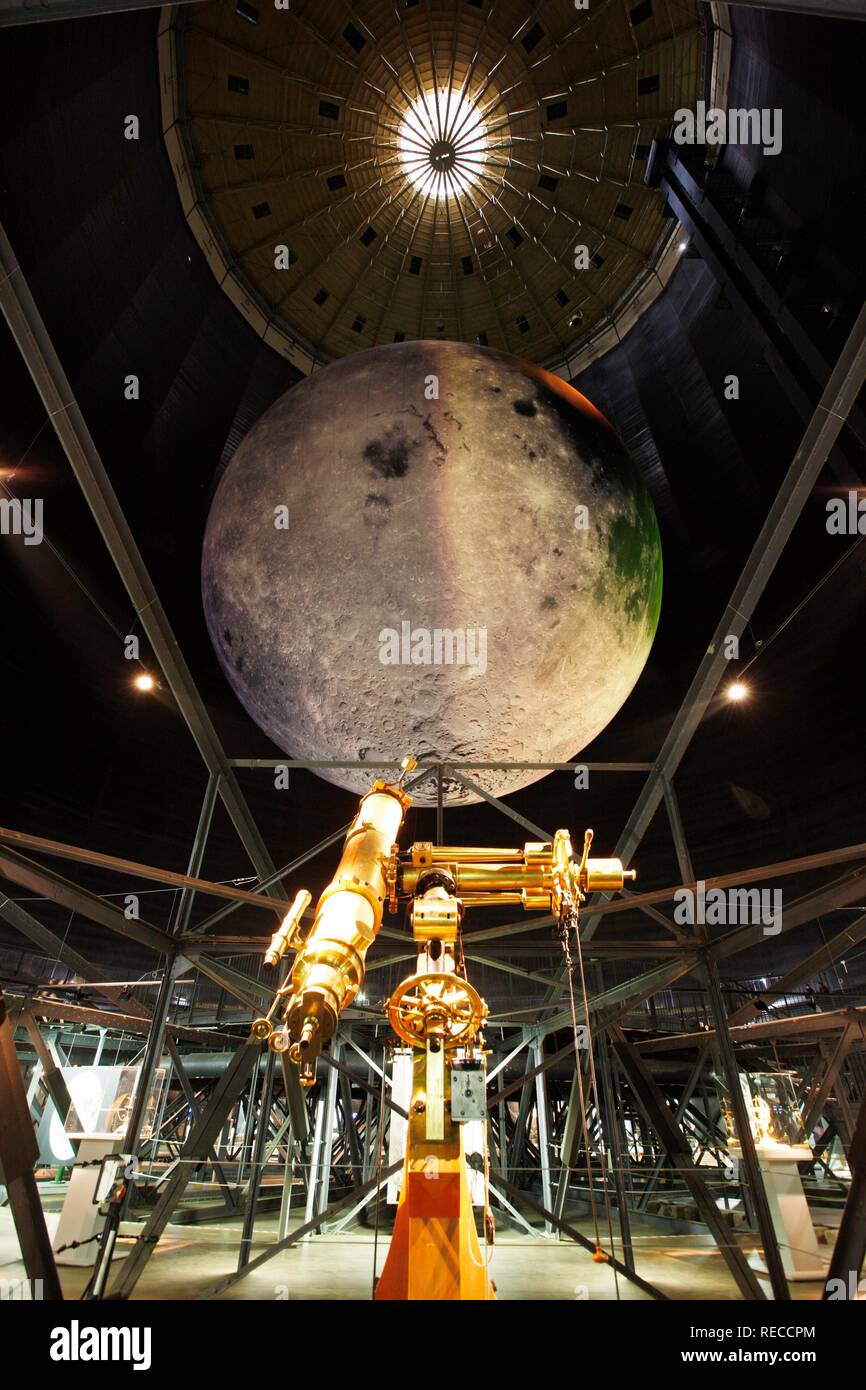 Historic telescope in front of a model of the Moon, Out of this World – Wonders of the Solar System Stock Photo