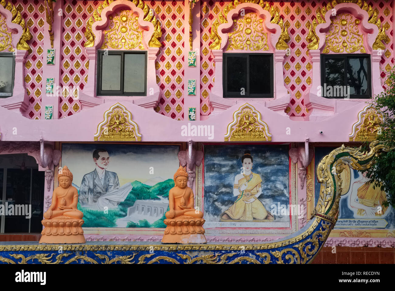 An administrative bldg. at Wat Phra Nang Sang, Thalang, Phuket, Thailand, with a painting of former King Bhumipol & wife Sirikit, and Buddha statues Stock Photo