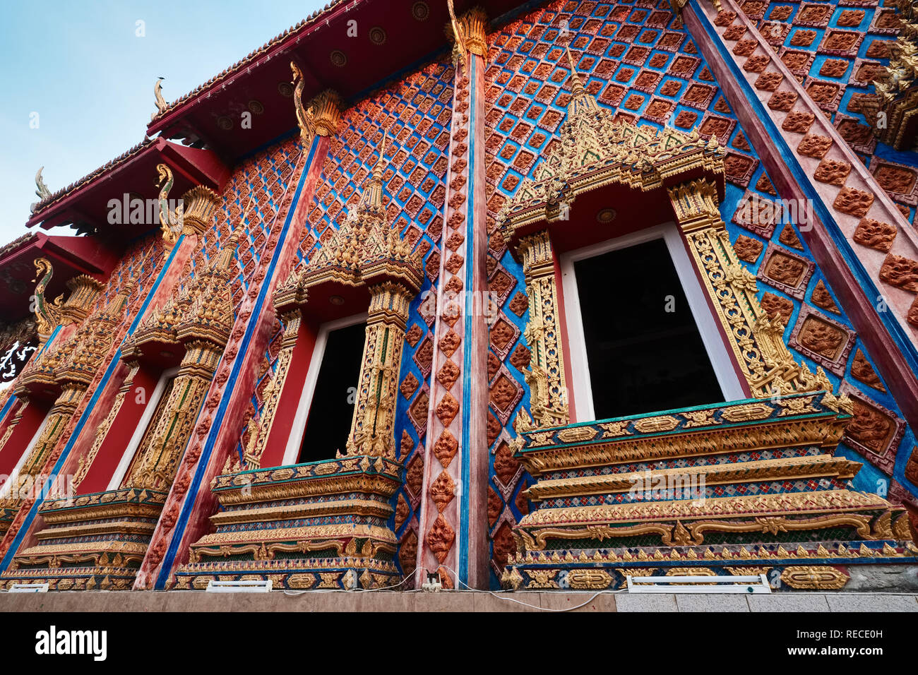 The elaborate windows and wall ornamentation of Wat Phra Nang Sang, Thalang, Phuket, Thailand Stock Photo