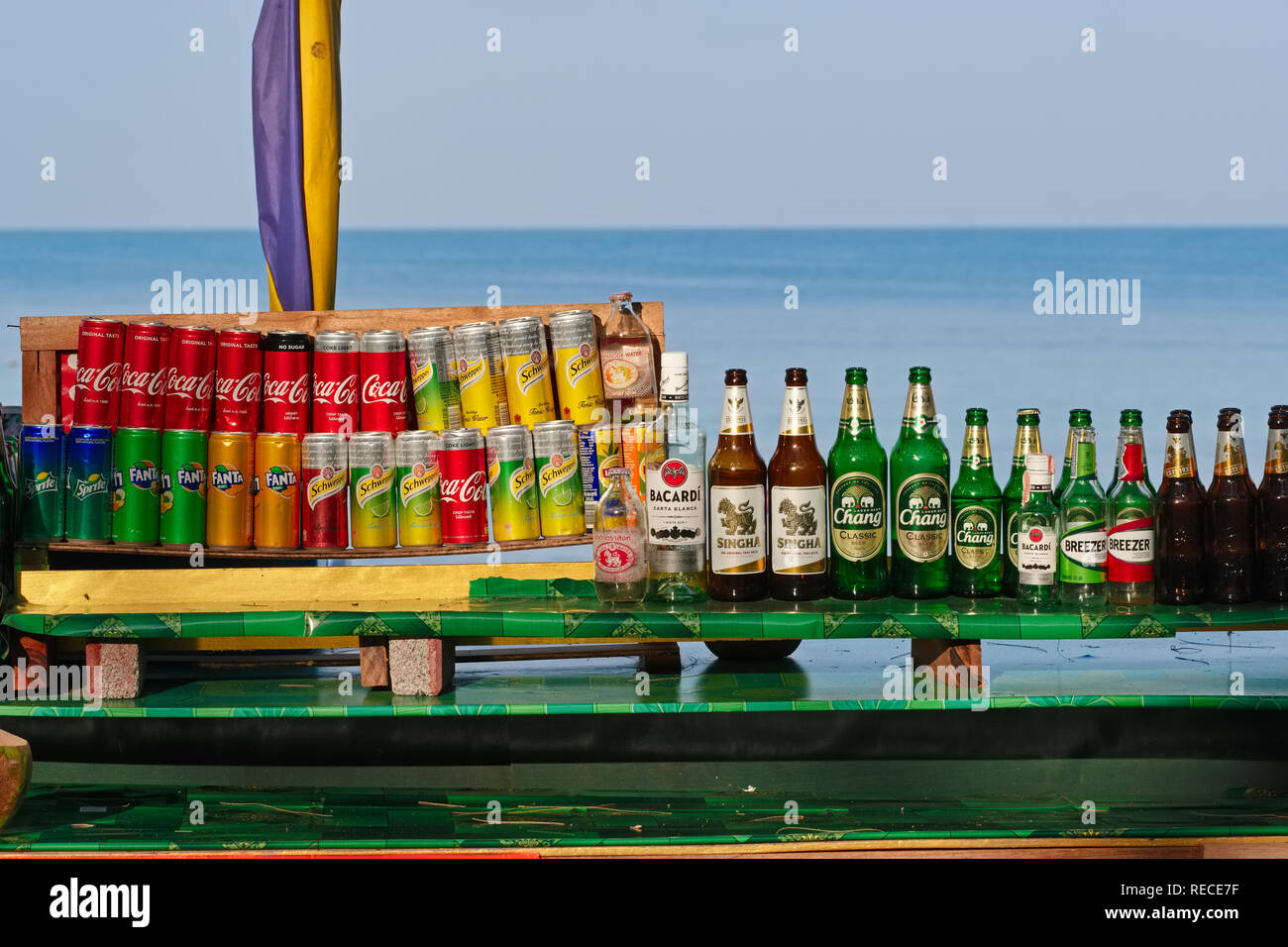 Cans of Coca Cola, other soft drinks & beer bottles at a beachside stall, on an early morning at Bang Tao (Bangtao) Beach, Bang Tao, Phuket, Thailand Stock Photo