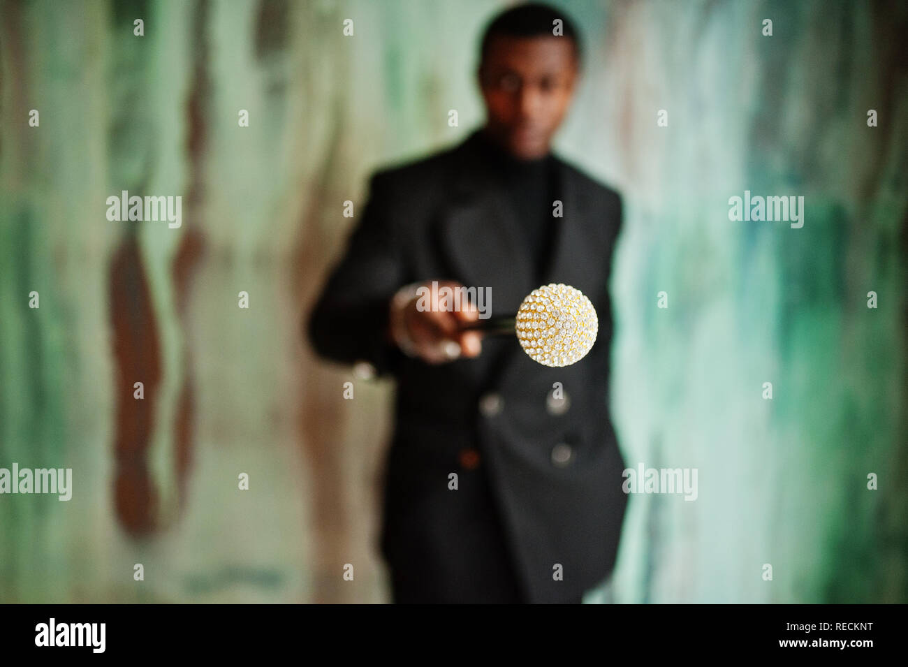 Stylish african american gentleman in elegant black jacket, holding retro walking  stick as cane flask or tippling cane with golden diamond ball handle Stock  Photo - Alamy