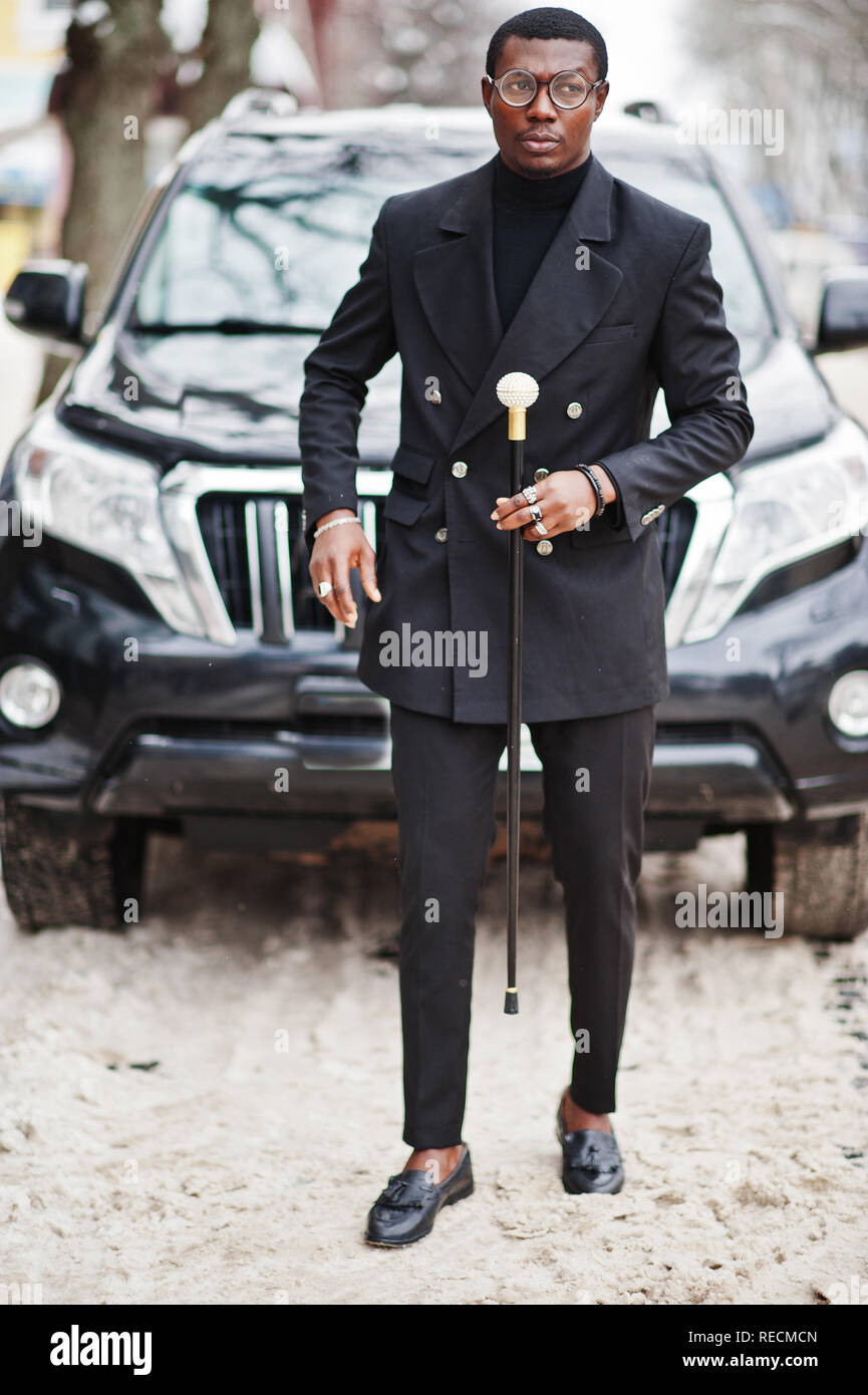 Stylish african american gentleman in elegant black jacket, holding retro walking  stick as cane flask or tippling cane with golden diamond ball handle Stock  Photo - Alamy