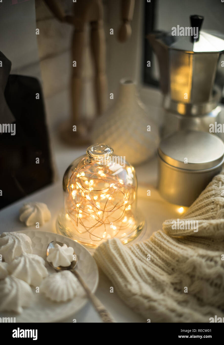 Cozy winter interior styling and decor, warm string lights in bell jar Stock Photo