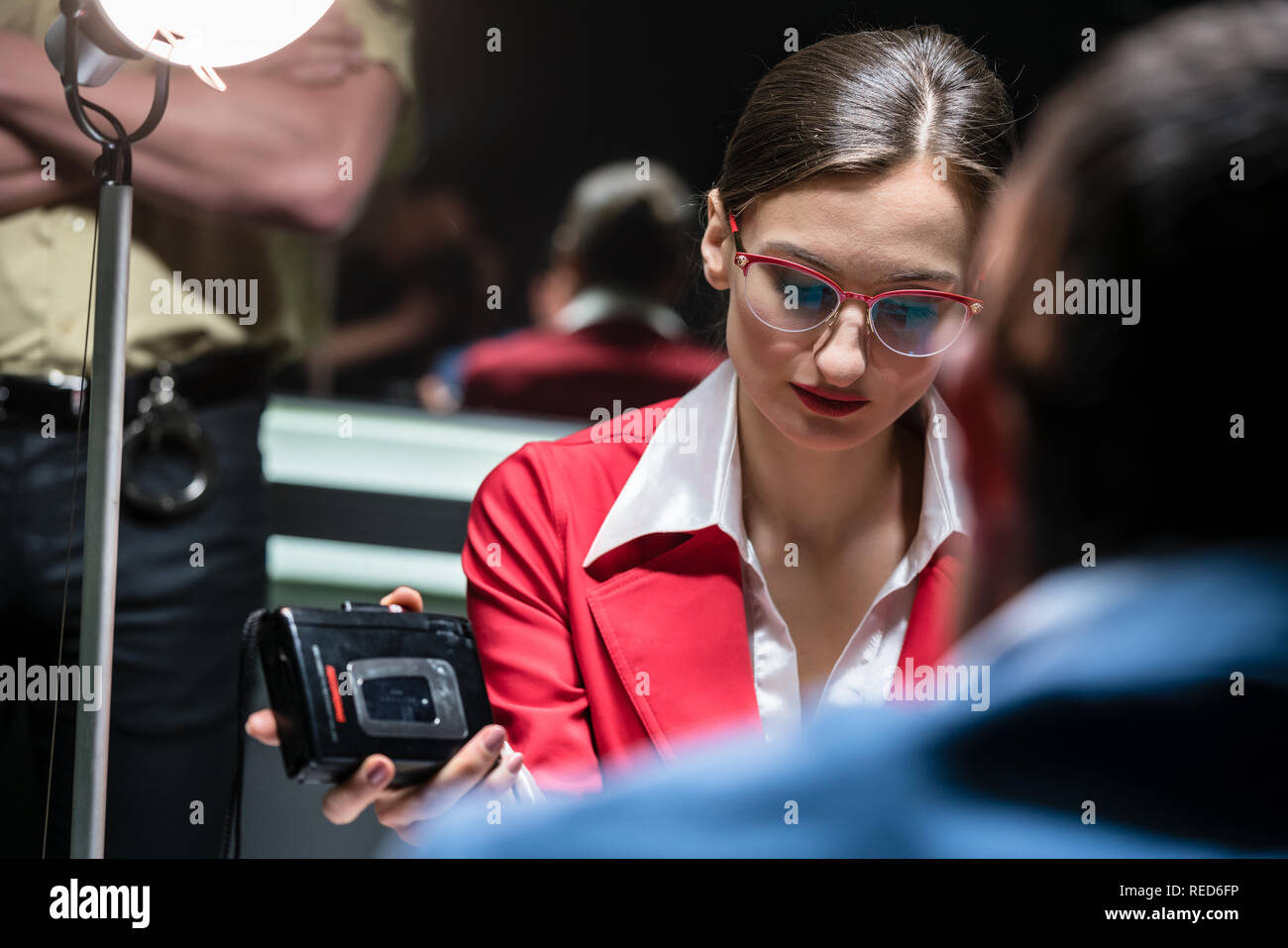 Police detective recording the statement of a suspect or witness Stock Photo