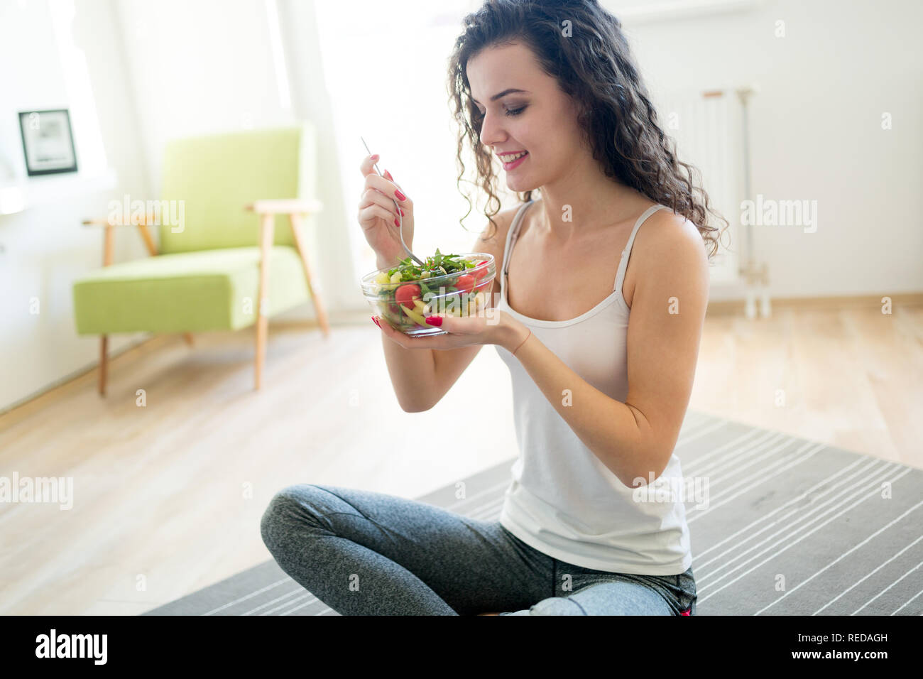 Fitness woman eating healthy food after workout Stock Photo