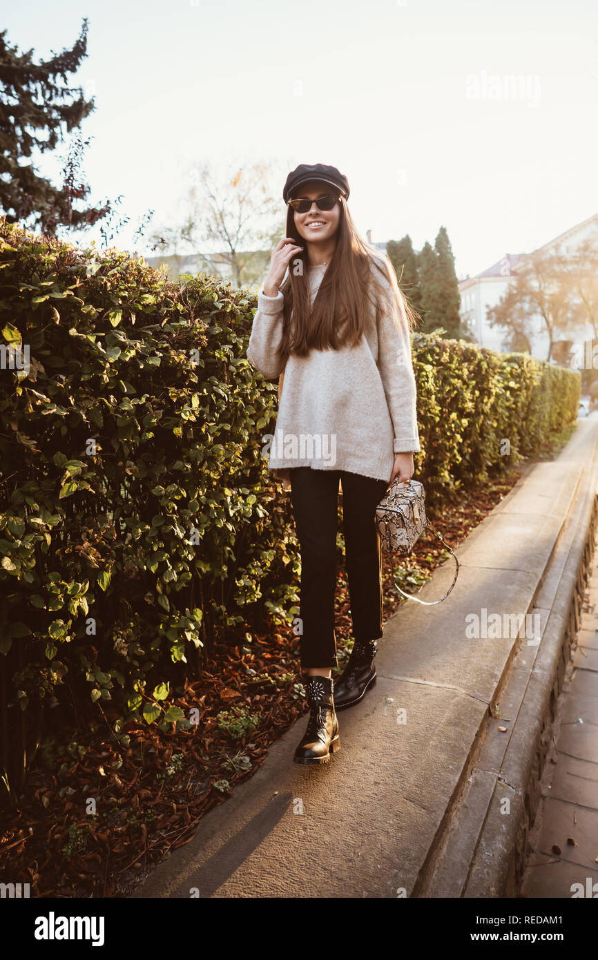 Beautiful young woman posing in the park near the hedge Stock Photo - Alamy