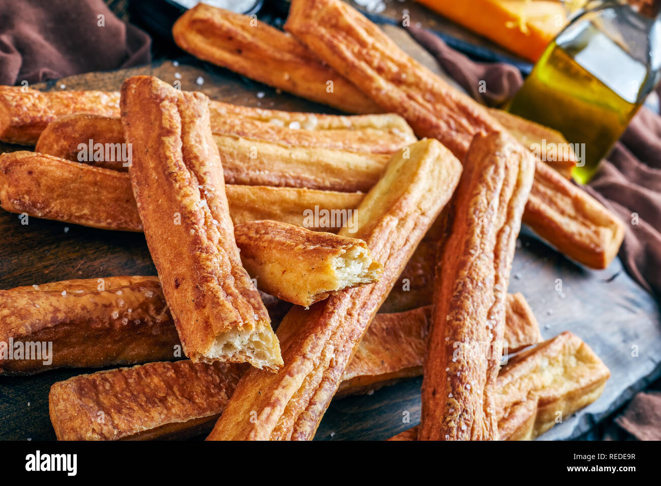 close-up of Cheese Straws, Cheesy Bread Sticks on a cutting wooden board, macro Stock Photo