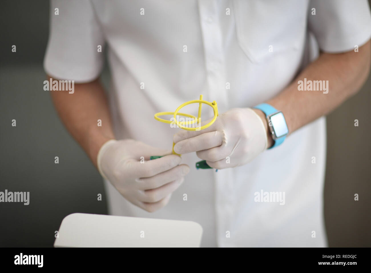 The dental assistant holds the positioner xray film holder in the