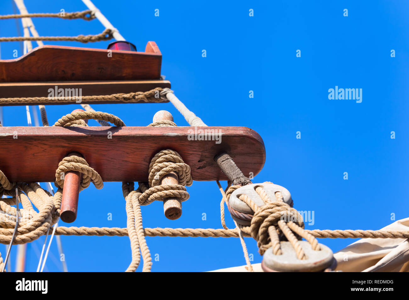 Jacobs ladder made of ropes at old sailing ship on nostalgic cruise, blue sky background (copy space) Stock Photo