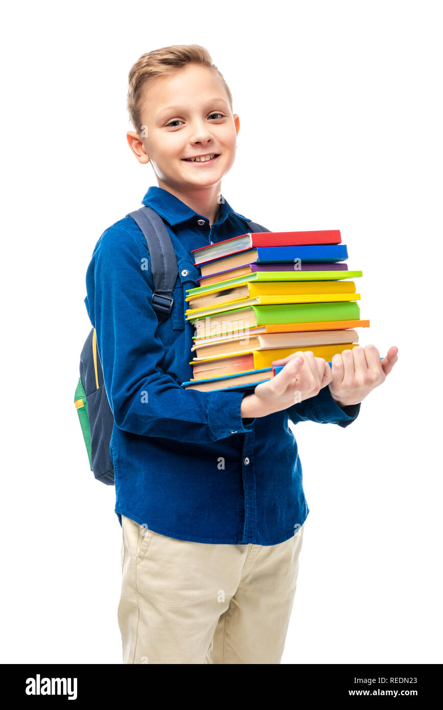 cute boy with backpack holding stack of books and looking at camera isolated on white Stock Photo