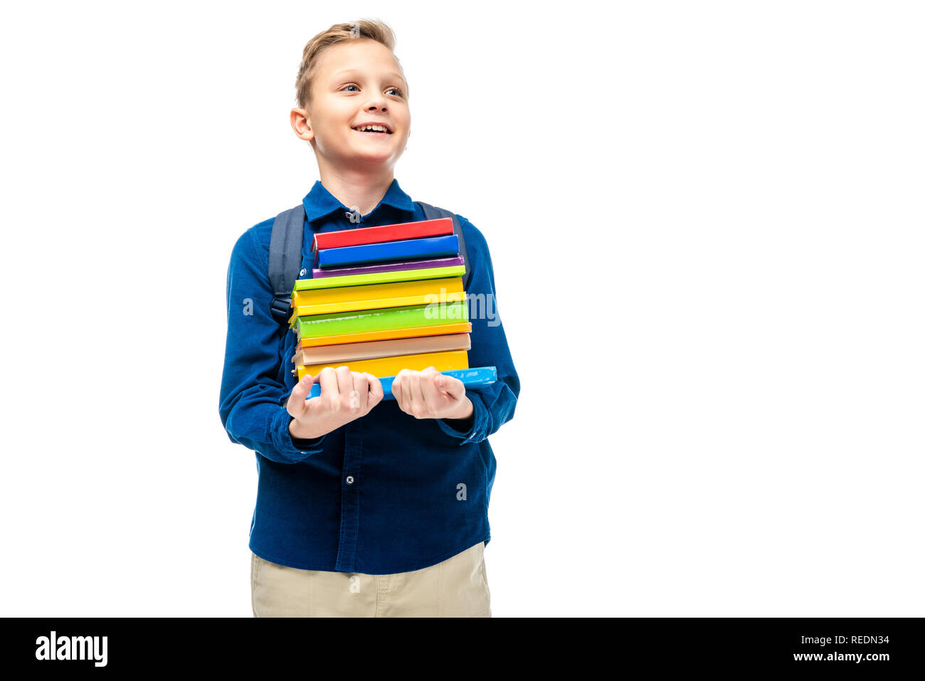 smiling boy holding stack of books isolated on white Stock Photo