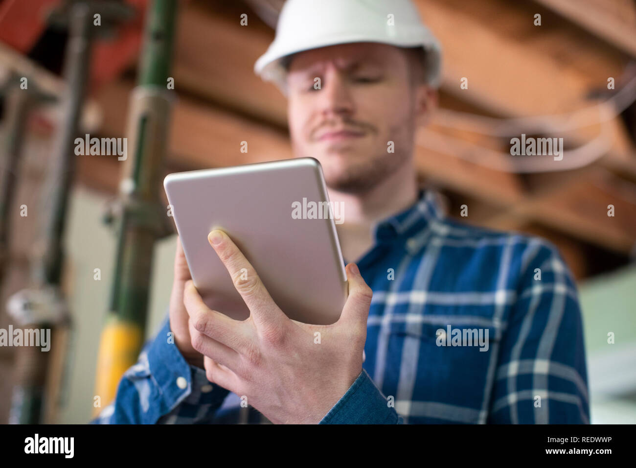 Architect Inside House Being Renovated Using Digital Tablet Stock Photo