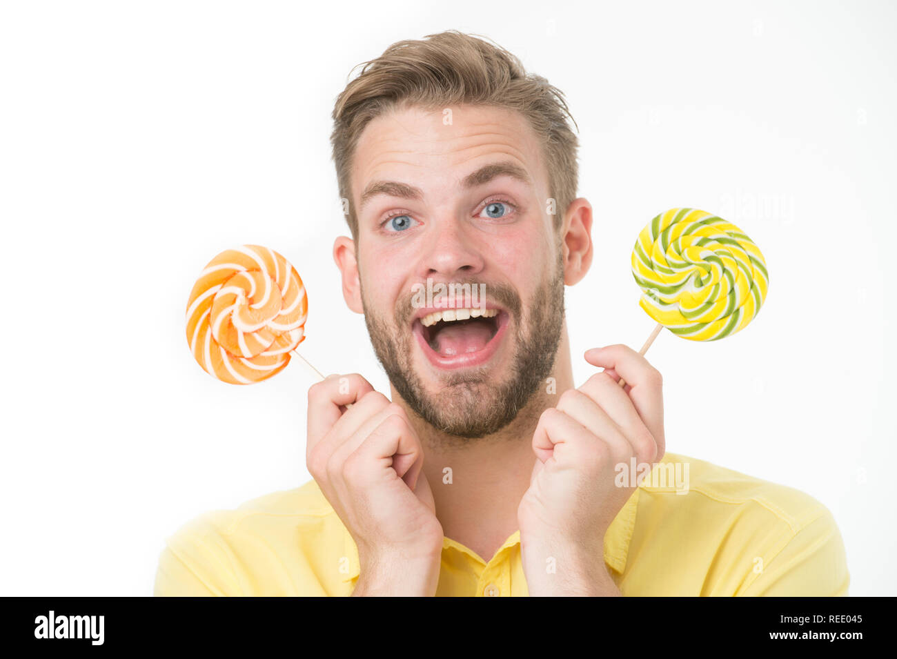 Impressing fact sugar nutrition. Man handsome bearded guy holds lollipop candy. Man with lollipop looks surprised. Healthy nutrition and dieting concept. Surprising effect sugar. Holiday sweet treats. Stock Photo