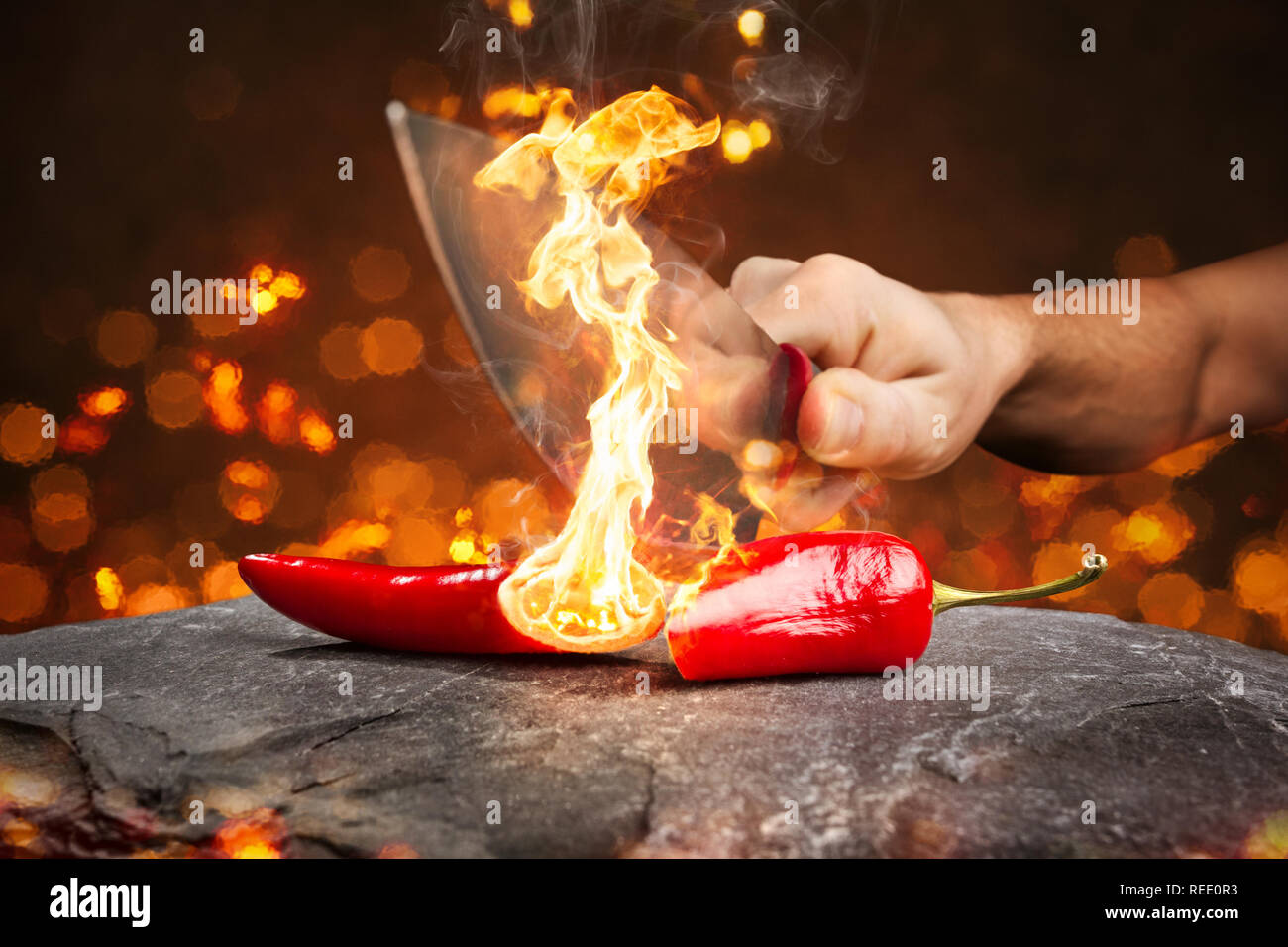 Burning chili pepper cut with a knife Stock Photo Alamy