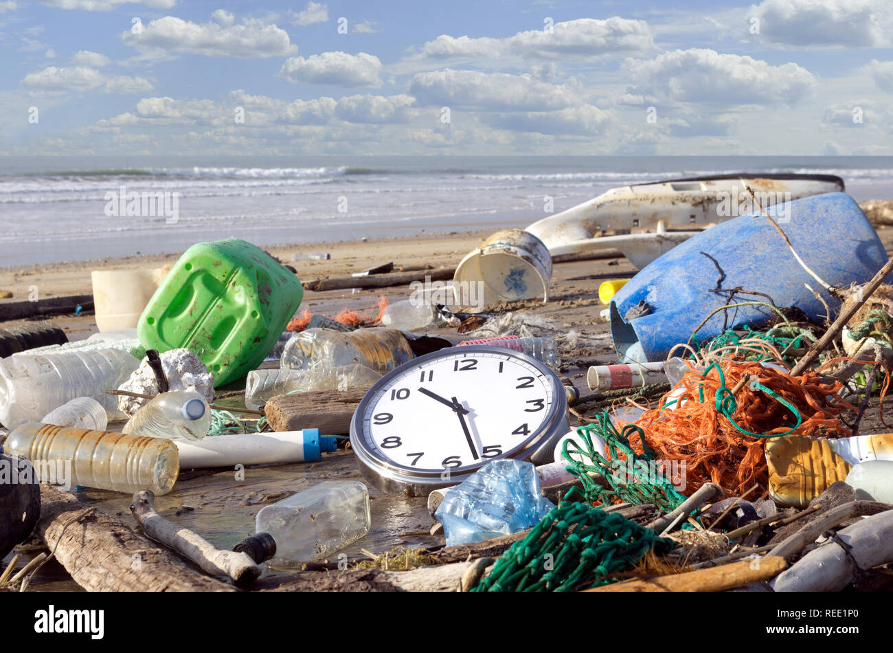 Trash beach pollution. Garbages, plastic, and wastes on the beach. Pollution: it’s time to wake up! Stock Photo