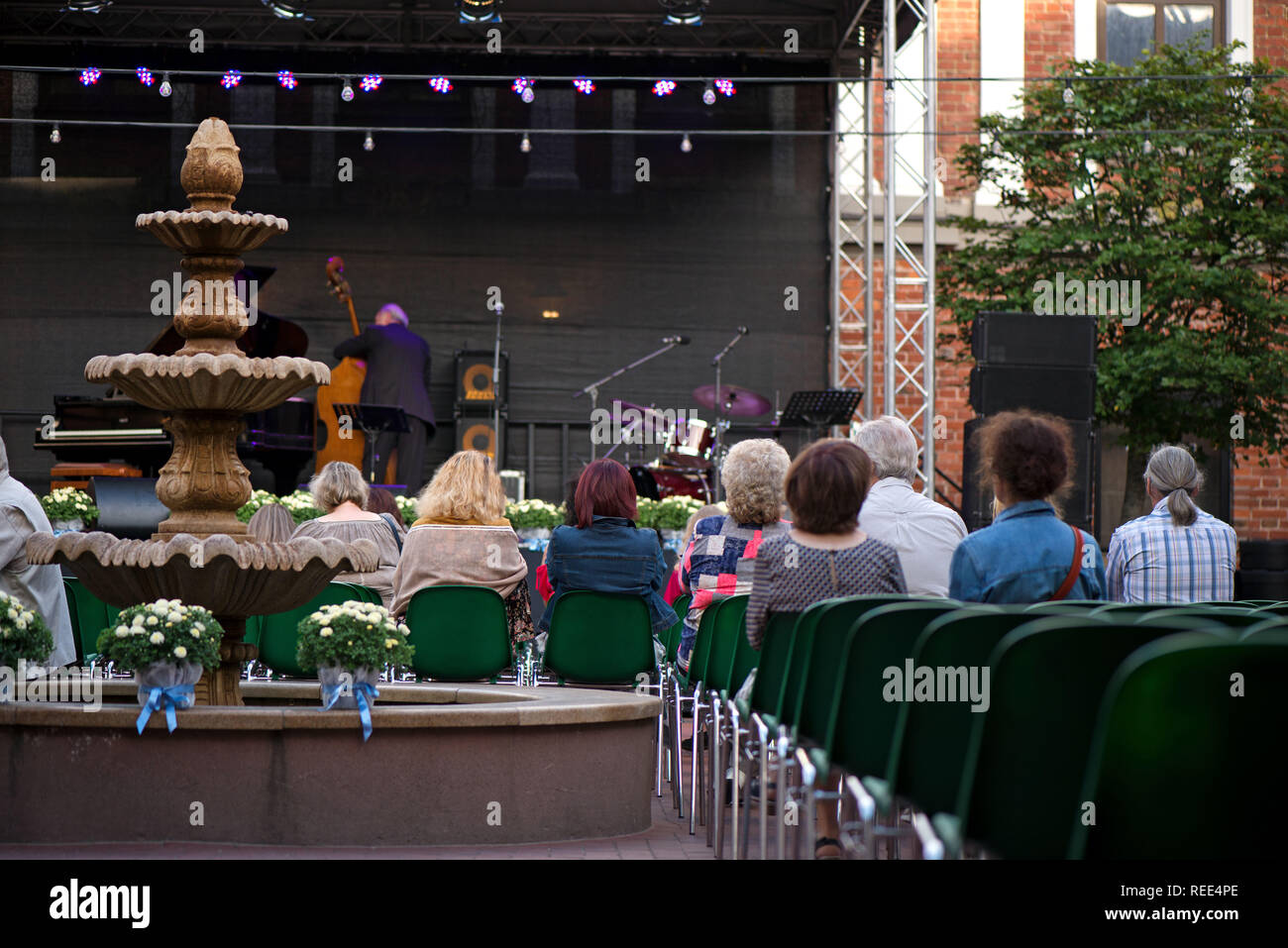 Beautiful fountain in crowded event. Audience enjoying romantic and