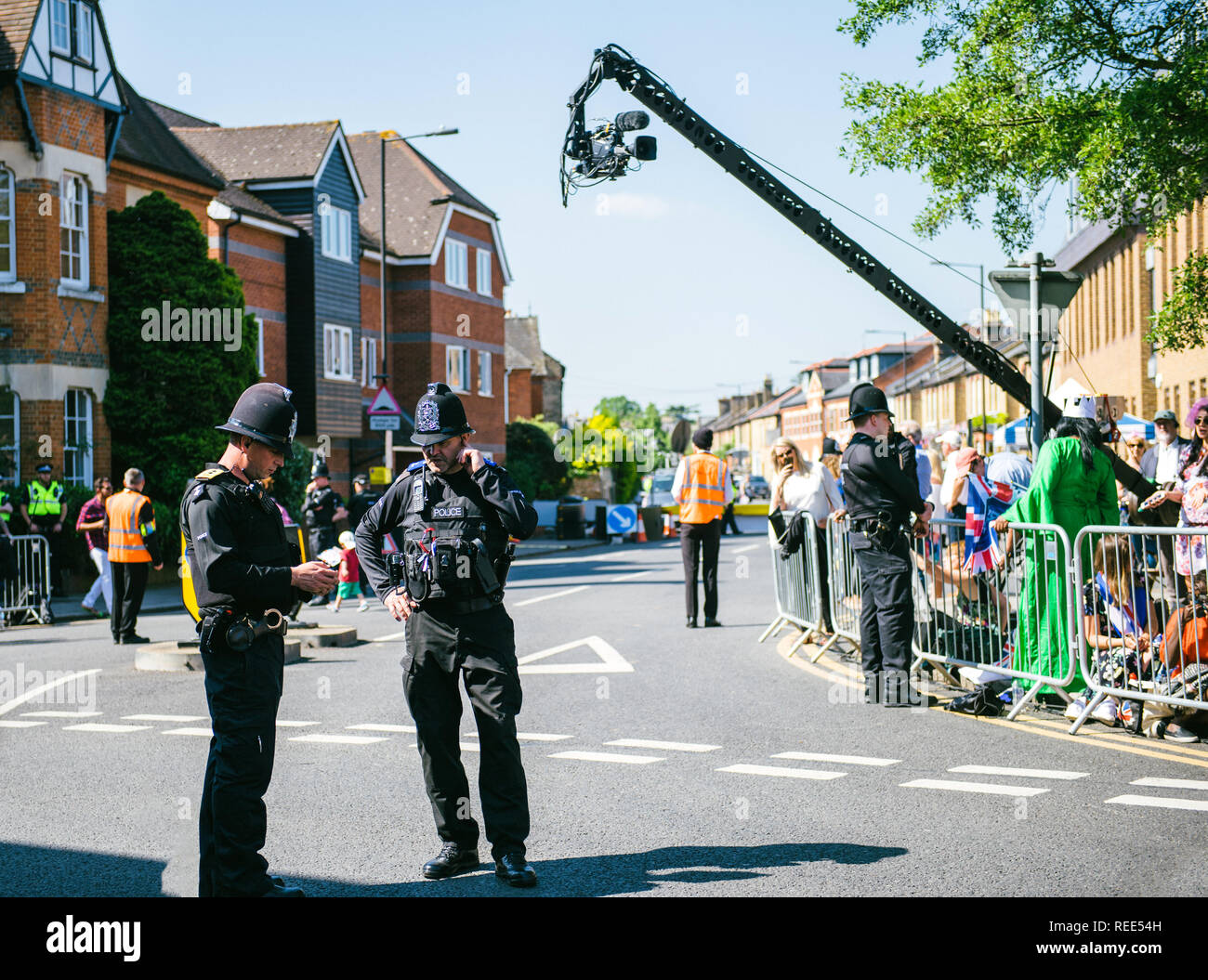 WINDSOR, UNITED KINGDOM - MAY 19, 2018: Broadcast TV camera, Constables police officers surveilling royal wedding marriage celebration of Prince Harry and Meghan Markle Stock Photo