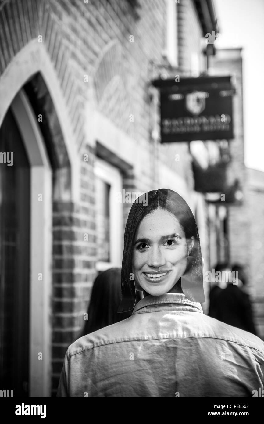 WINDSOR, BERKSHIRE, UNITED KINGDOM - MAY 19, 2018: Man wearing with Meghan Marke mask walking on Windsor street to attend the royal wedding marriage celebration of Prince Harry and Meghan Markle   Stock Photo