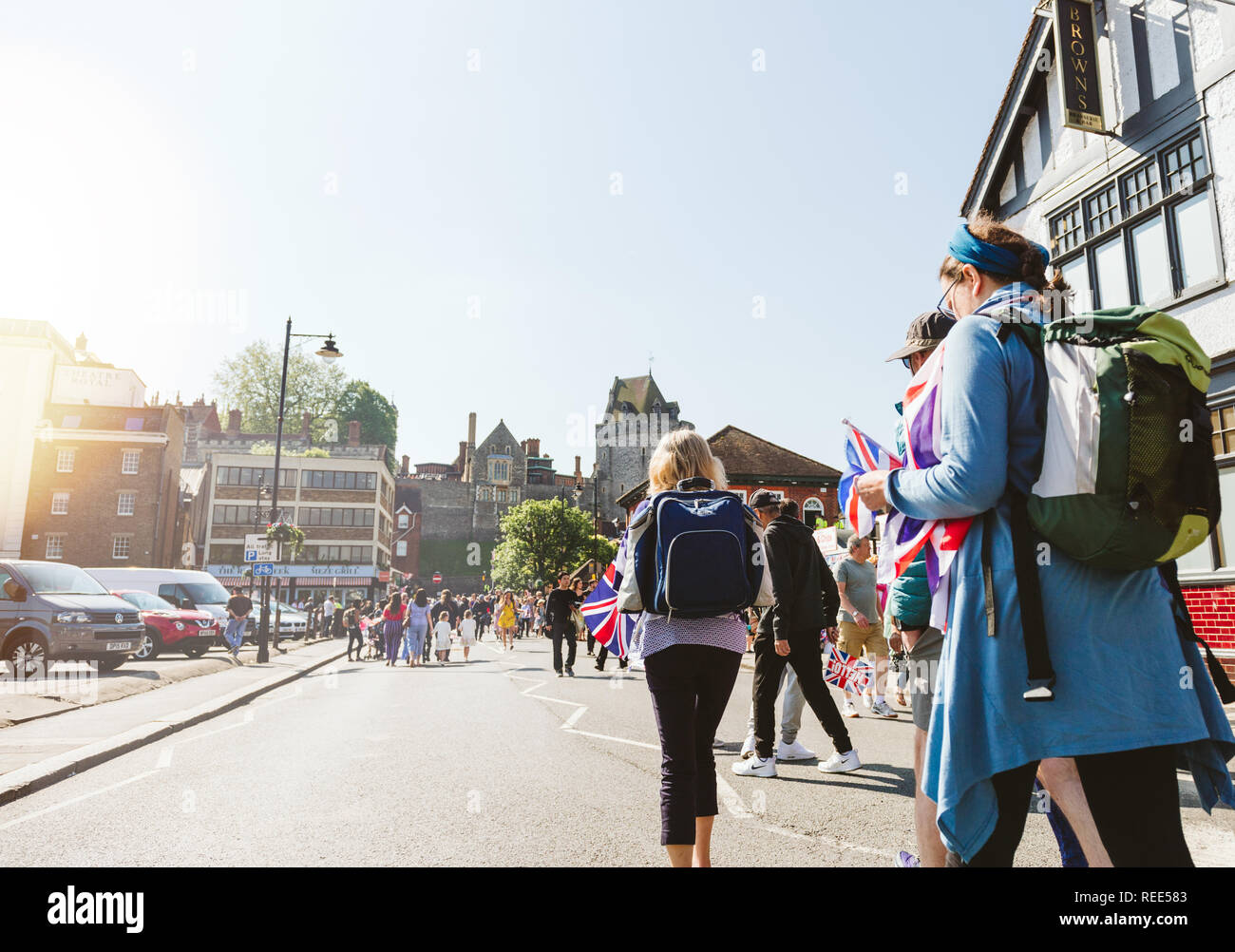 WINDSOR, BERKSHIRE, UNITED KINGDOM - MAY 19, 2018: Travelers walking to royal wedding marriage celebration of Prince Harry and Meghan Markle to Windsor Castle  Stock Photo