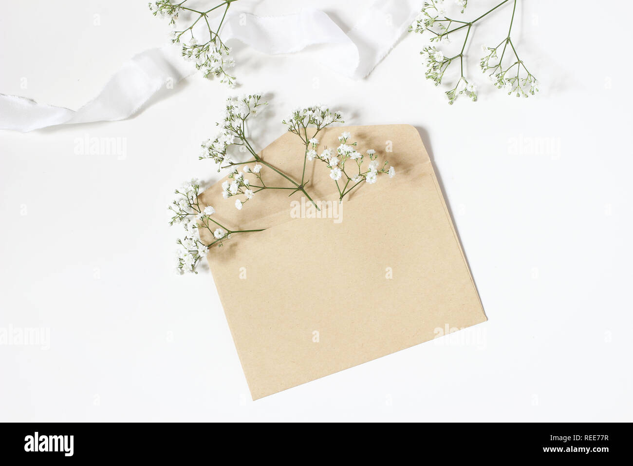 Download Styled Stock Photo Feminine Wedding Desktop Mockup With Baby S Breath Gypsophila Flowers Satin Ribbon And Blank Craft Paper Envelope Mockup On White Stock Photo Alamy PSD Mockup Templates
