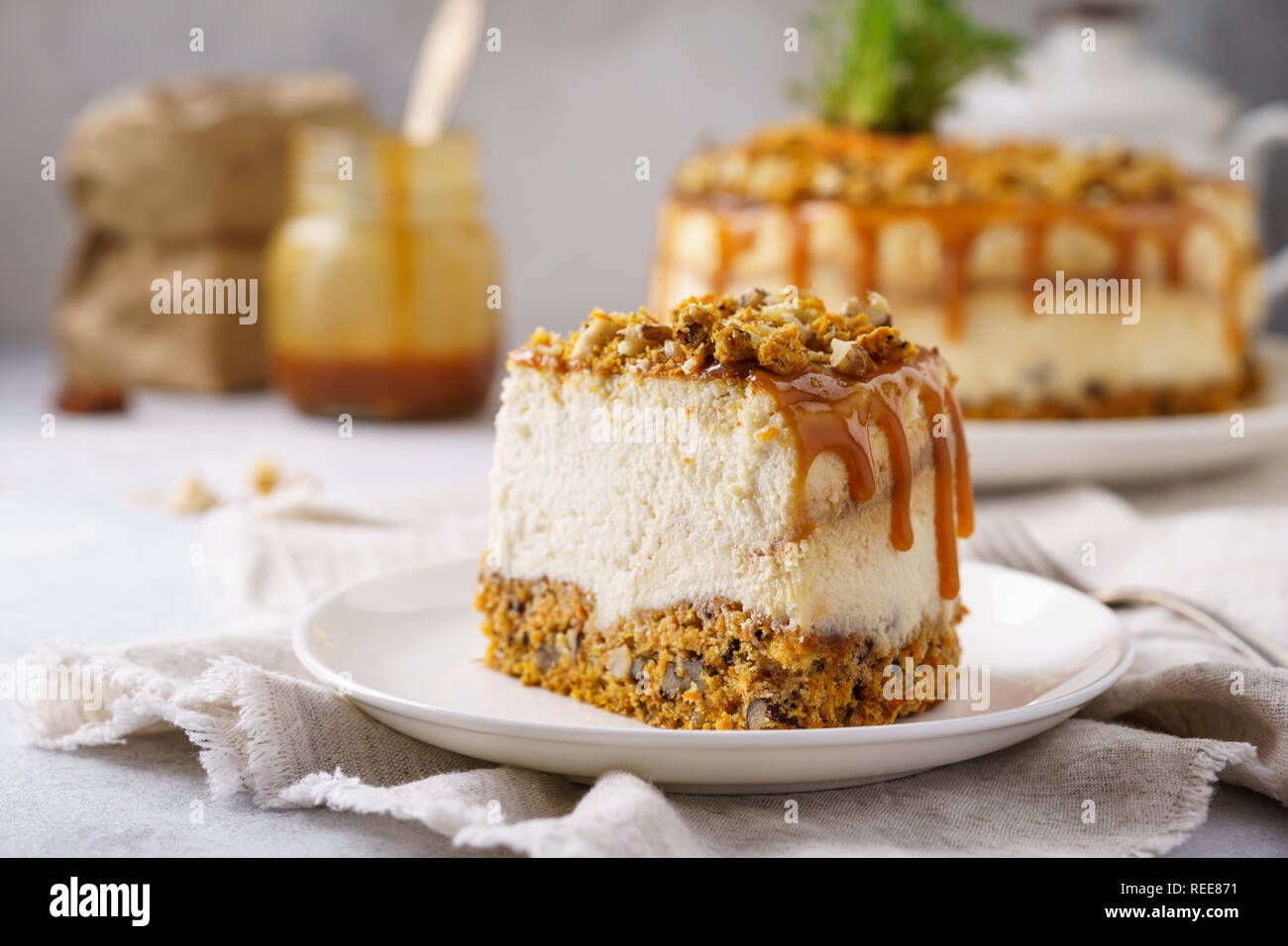 Piece of carrot cheesecake with nuts and salted caramel topping. Easter
