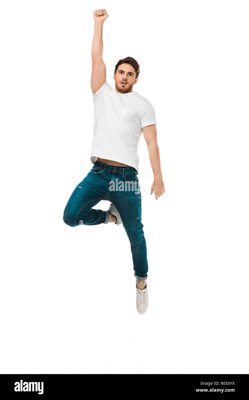 serious handsome man jumping with raised hand and looking at camera isolated on white Stock Photo