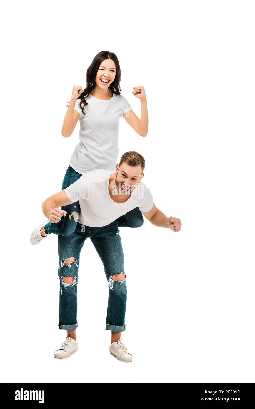 happy young couple piggybacking and smiling at camera isolated on white Stock Photo
