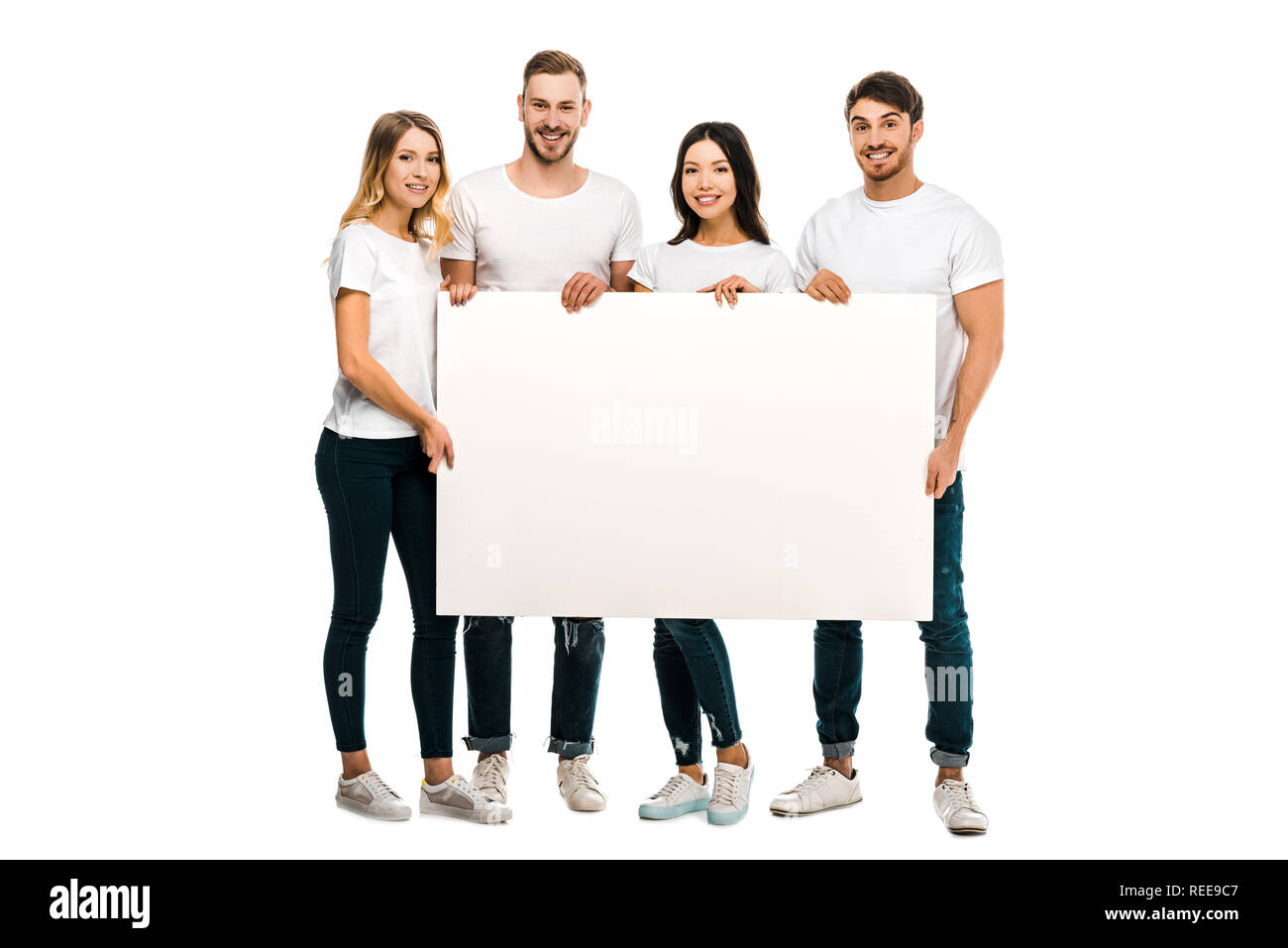 happy young people holding blank placard and smiling at camera isolated ...
