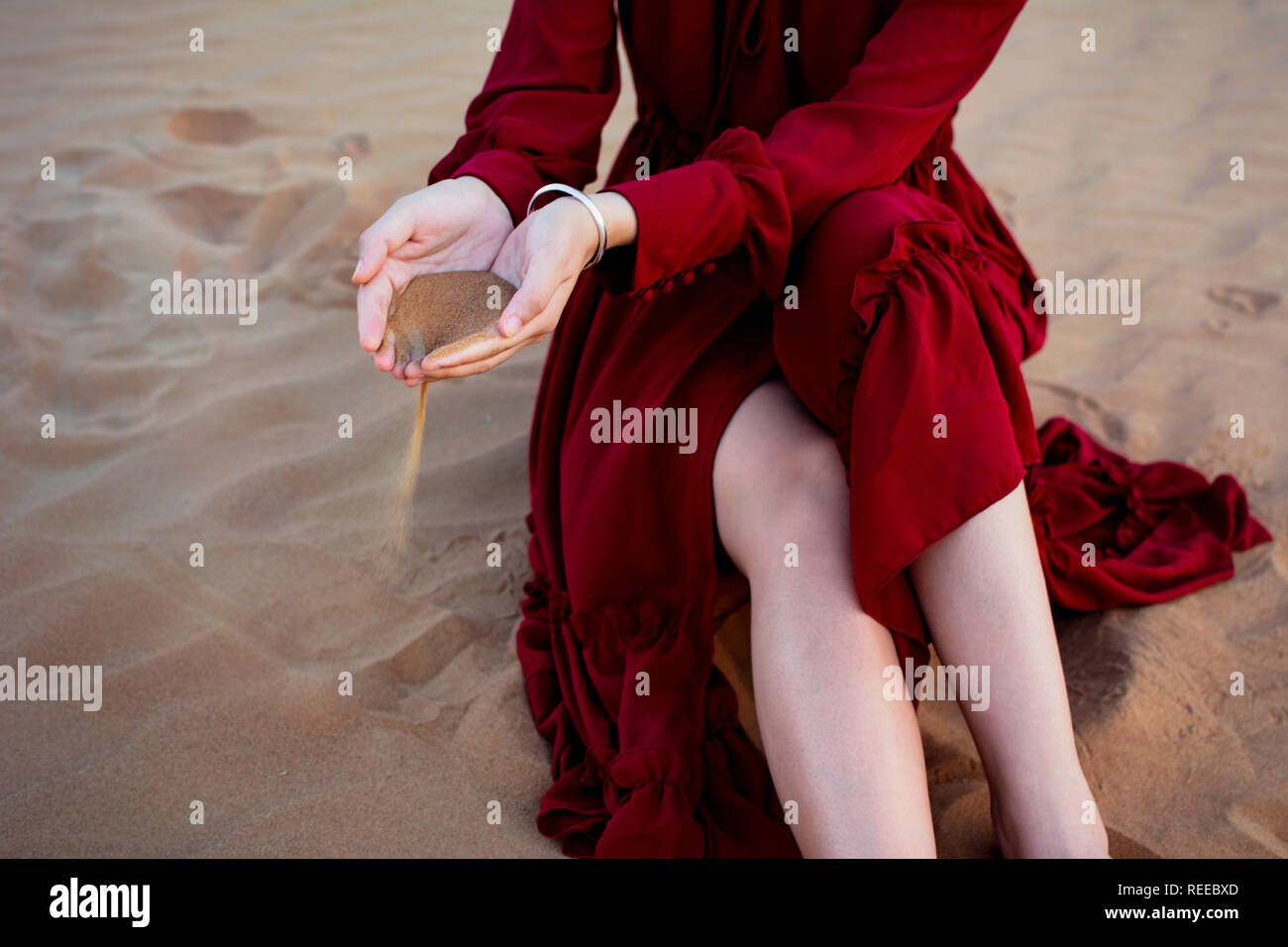 Woman holding sand in the desert close up view Stock Photo