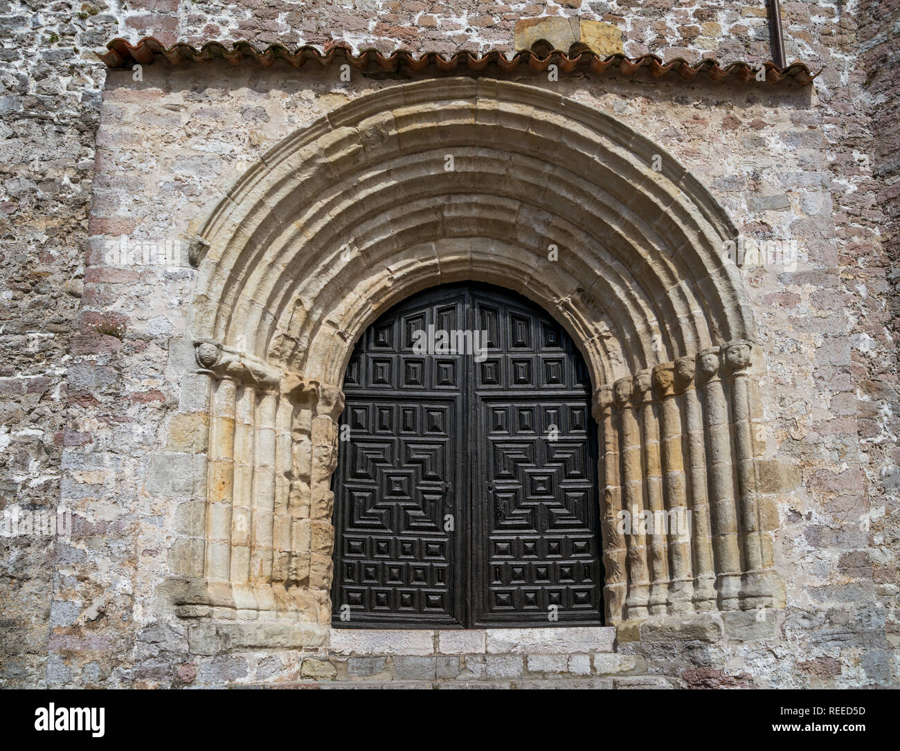 Romanesque portal of Iglesia de Santa María del Conceyu in Llanes, Asturias, Spain Stock Photo