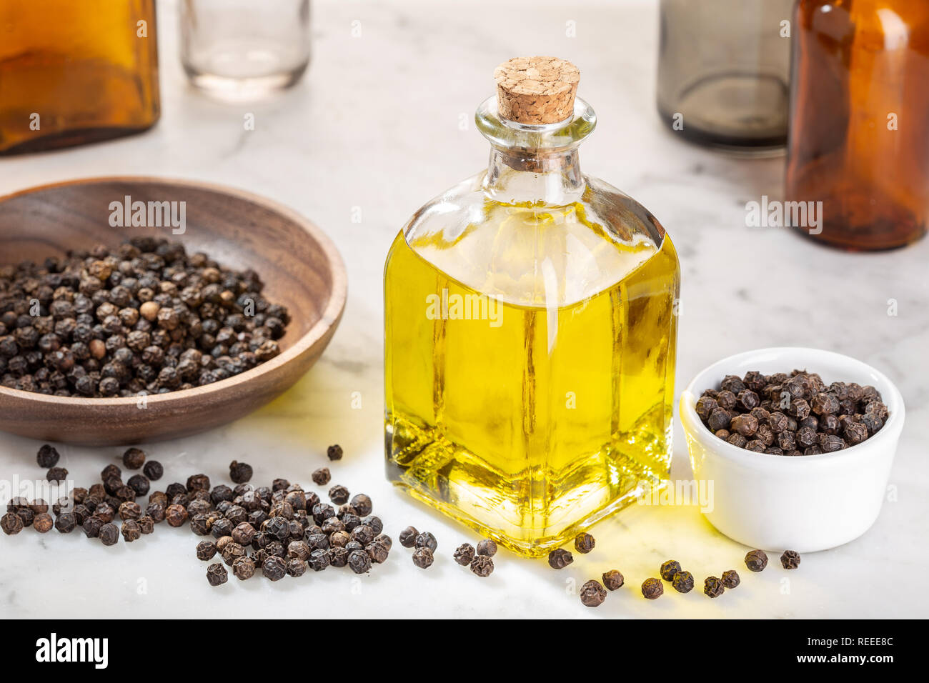 Black pepper essential oil. Black pepper oil glass bottle for beauty, skin care, wellness and medicinal purposes. Piper nigrum oil Stock Photo
