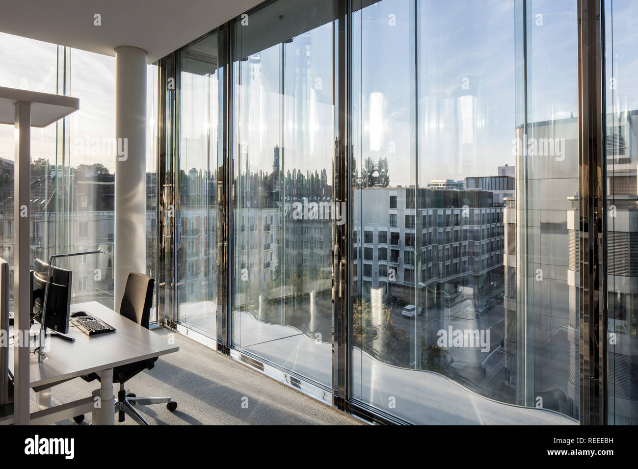 Office interior with window walls and view to city. Swiss Re Office ...