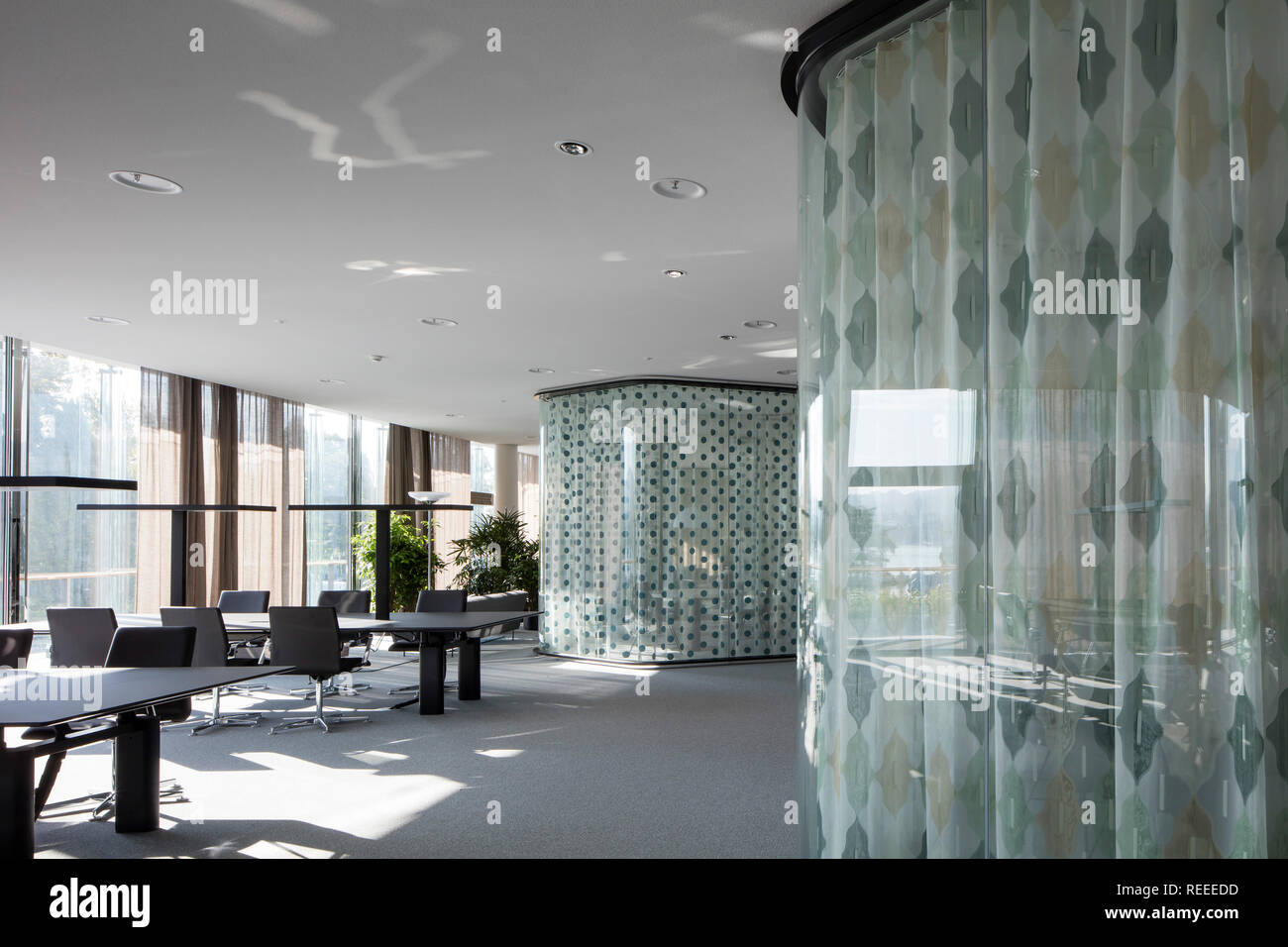 Open plan office with glazed think tanks. Swiss Re Office headquarters