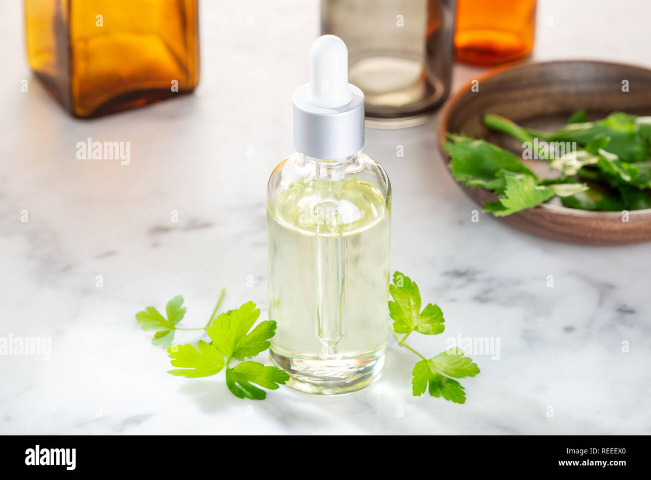 Parsley essential oil. Parsley oil for skin care, spa, wellness, massage, aromatherapy and natural medicine Stock Photo