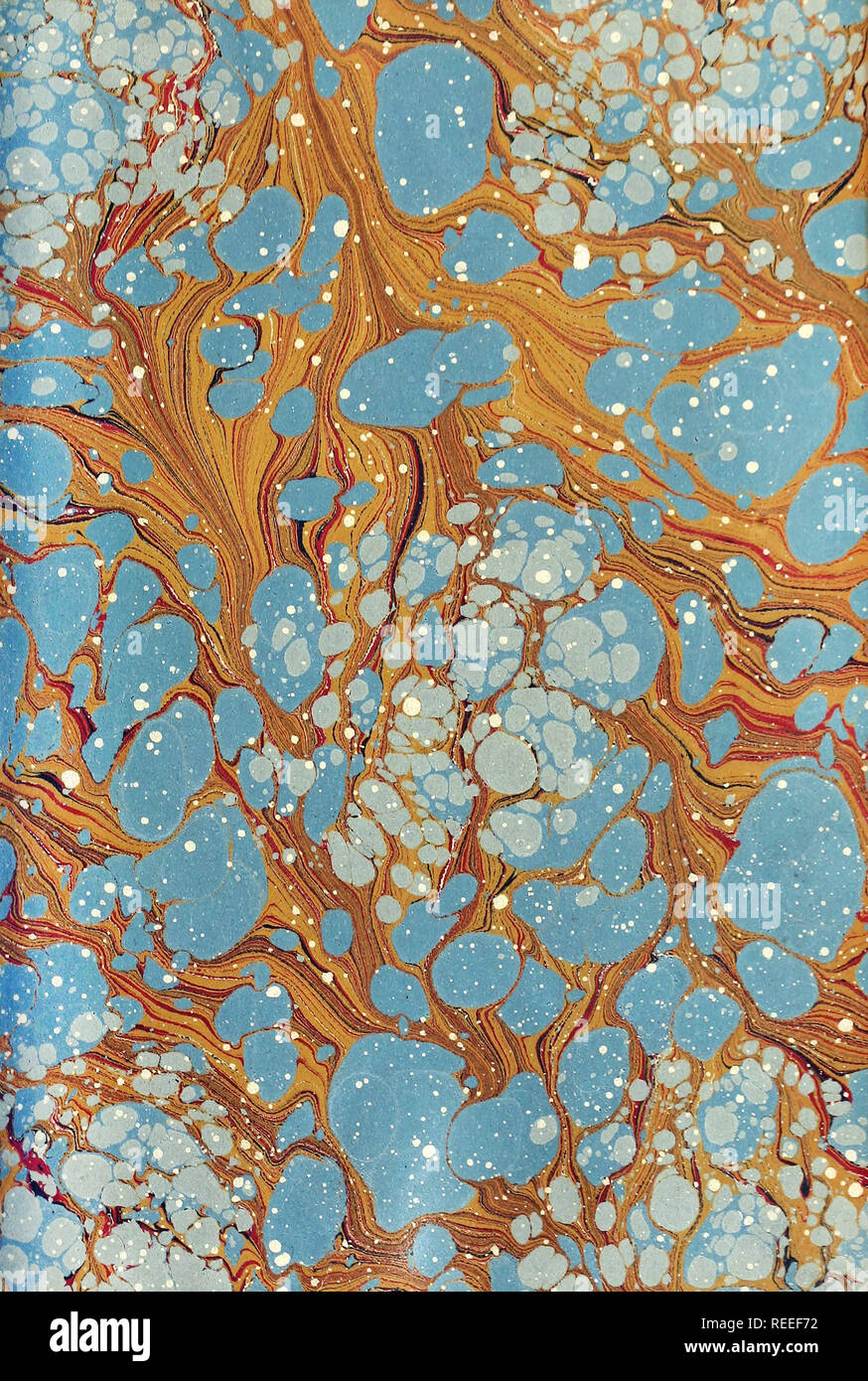 A handmade marble patterned paper in blue and brown. Stock Photo