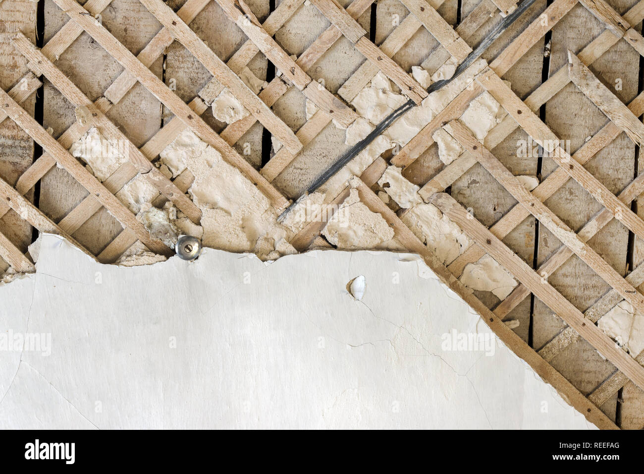 Destroyed old ceiling before repair. Old wall decor background ...