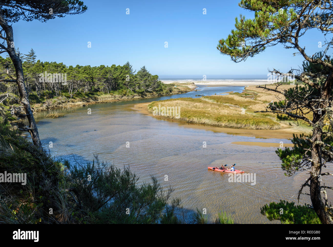 Couple Paddling Kayak On The Siltcoos River, Oregon Dunes National 