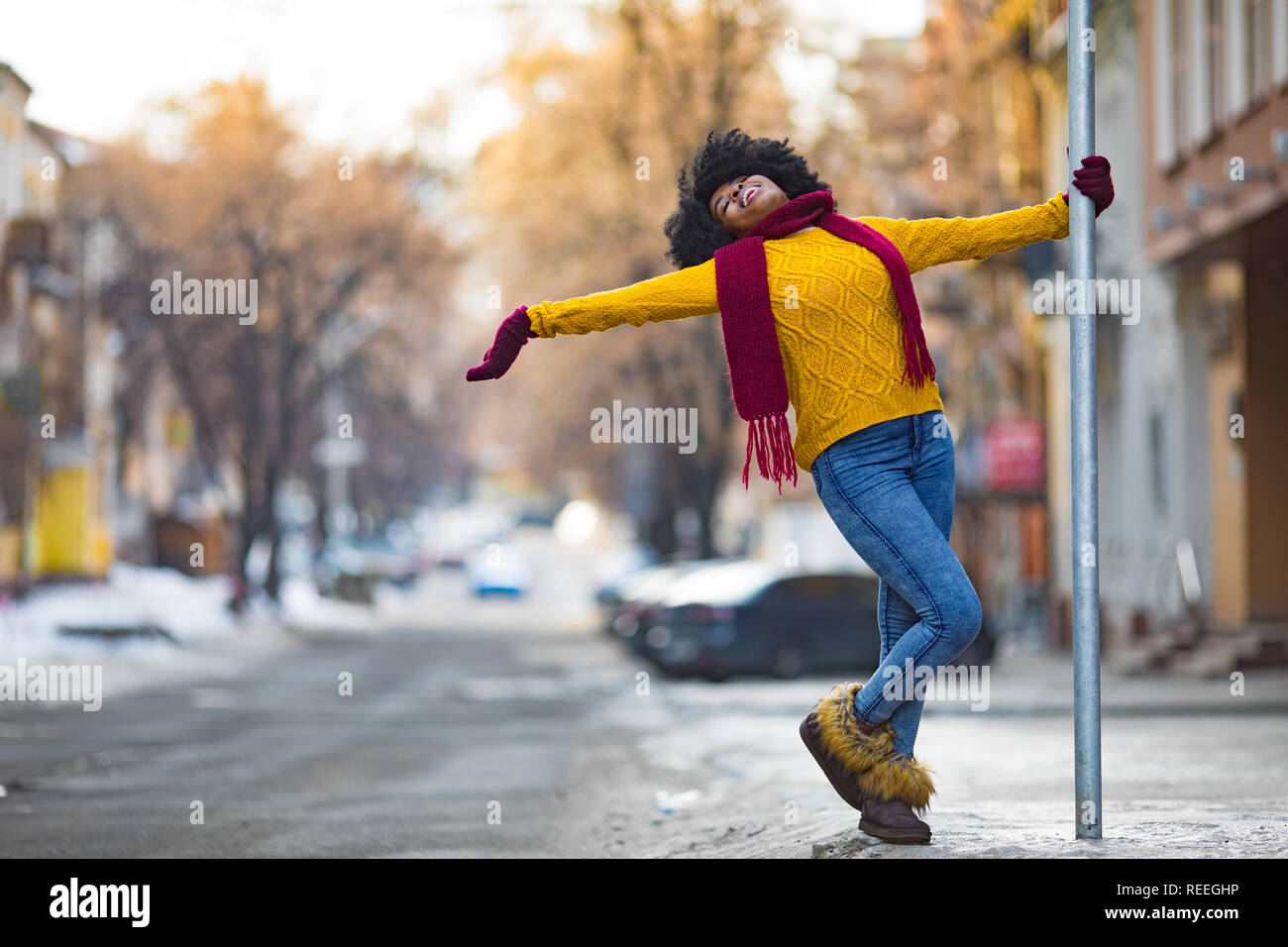 Happy young black woman is walking to the city street and smiling Stock ...