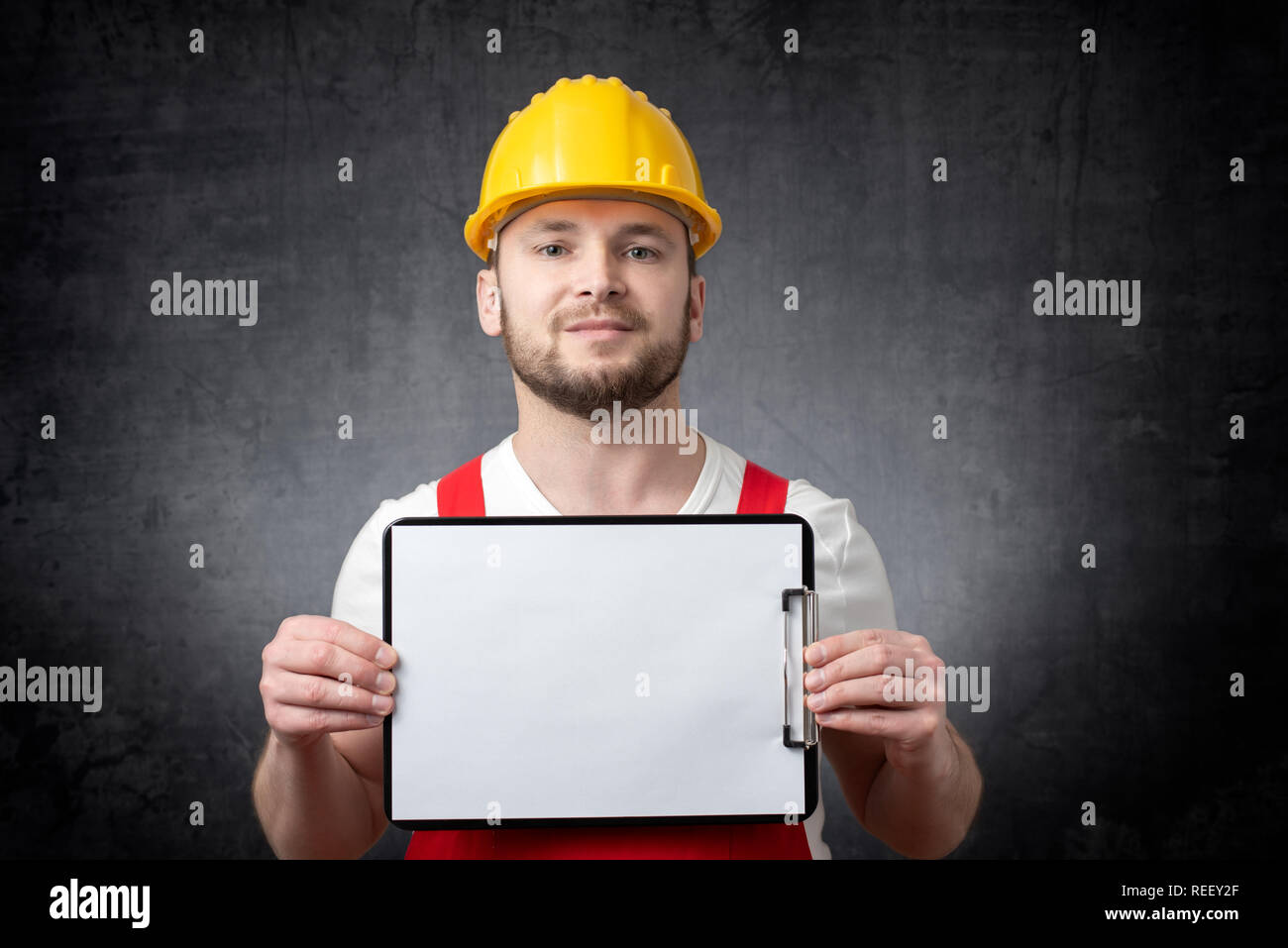 Worker showing blank clipboard Stock Photo