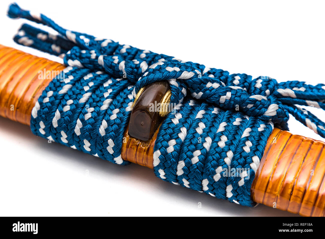 Blue sageo: cord for tie the rattan wrapped scabbard of Japanese sword and steel fitting isolated in white background. Stock Photo