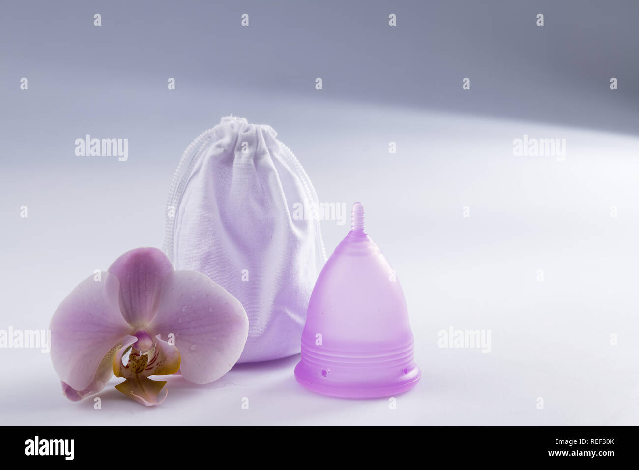 menstrual cup on an old wooden table withe white paint Stock Photo