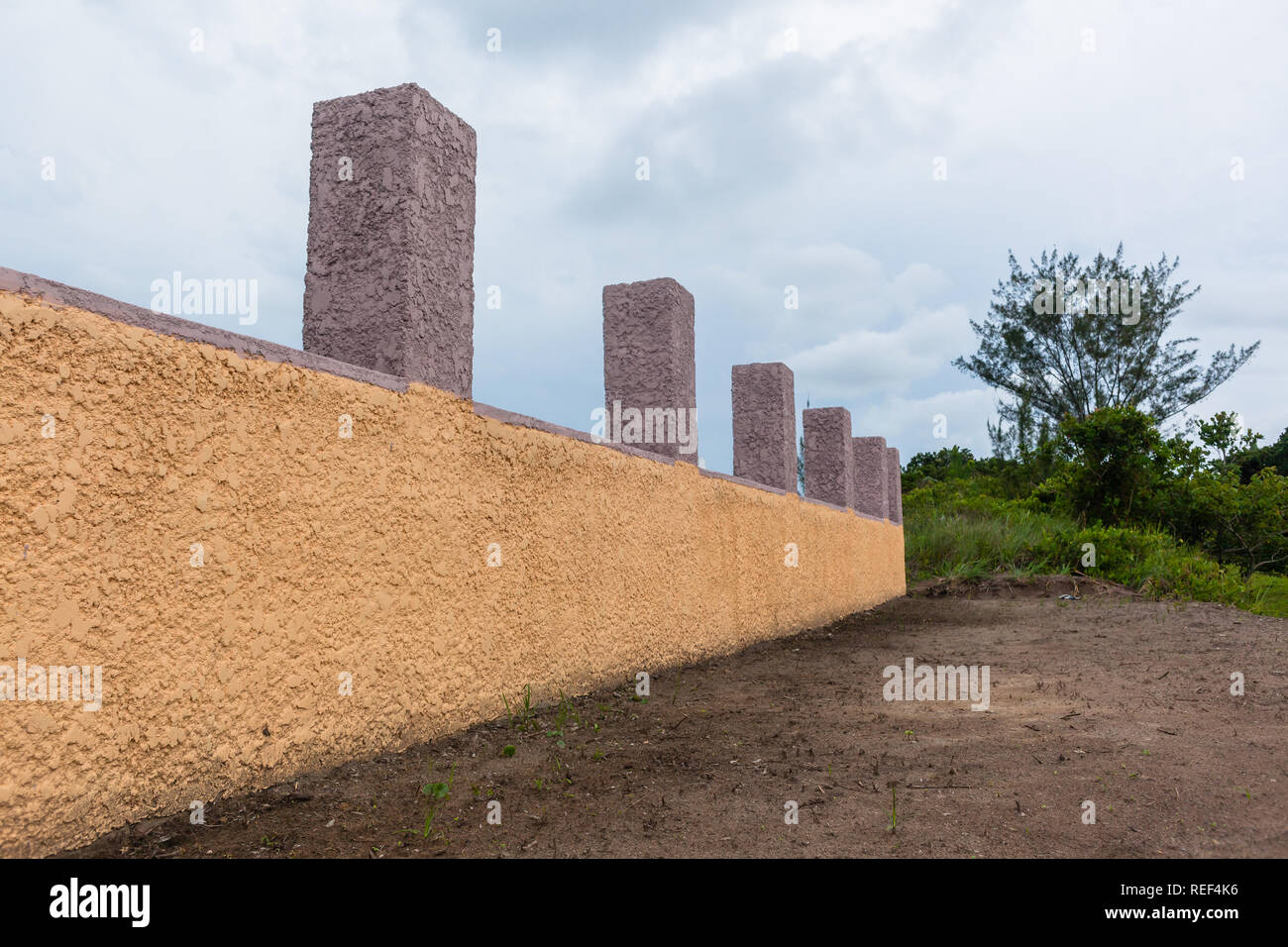 New boundary wall fence under construction with block concrete plaster